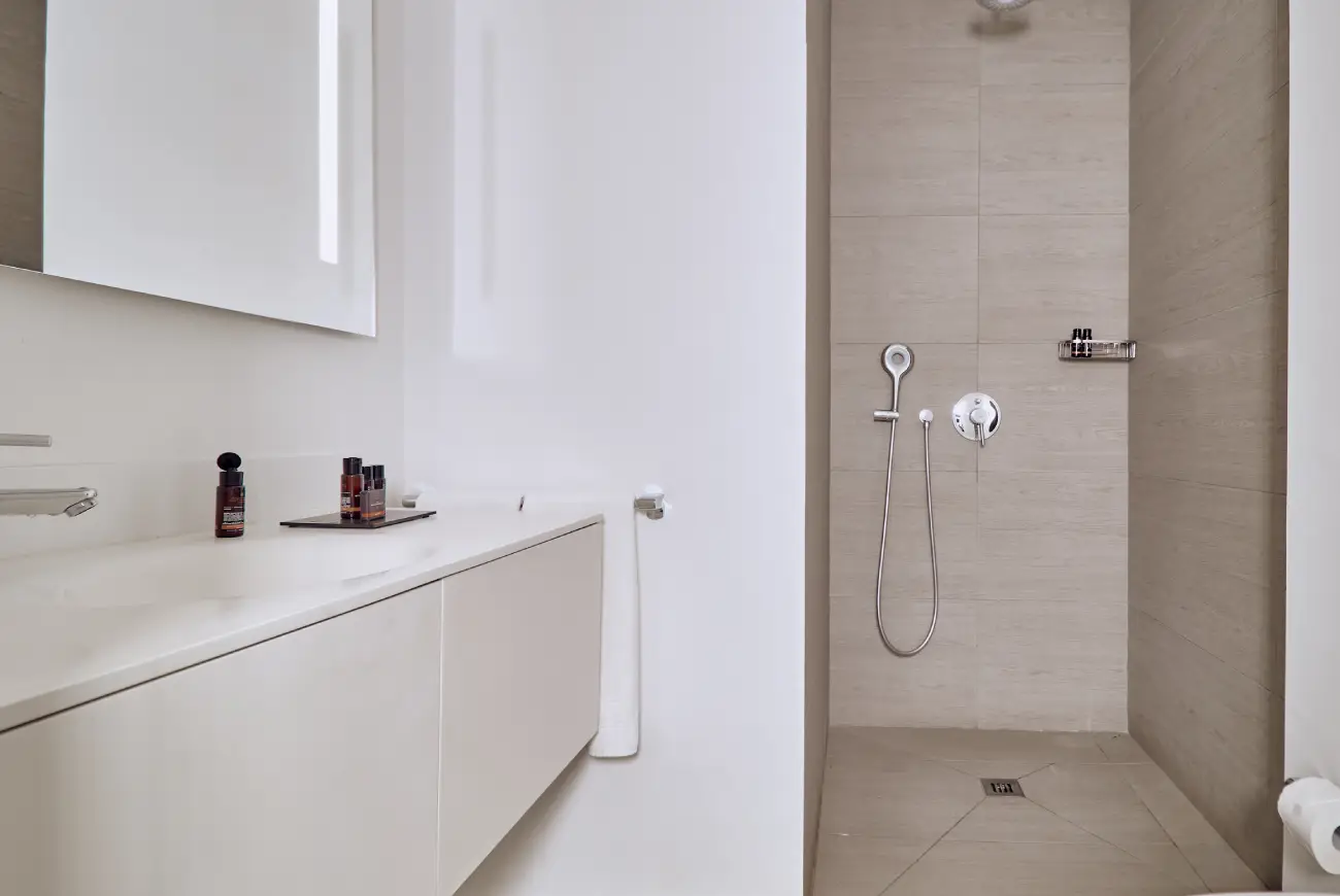 Bathroom in the Baobab Suites Emerald One Bedroom Suite with walk-in shower and vanity