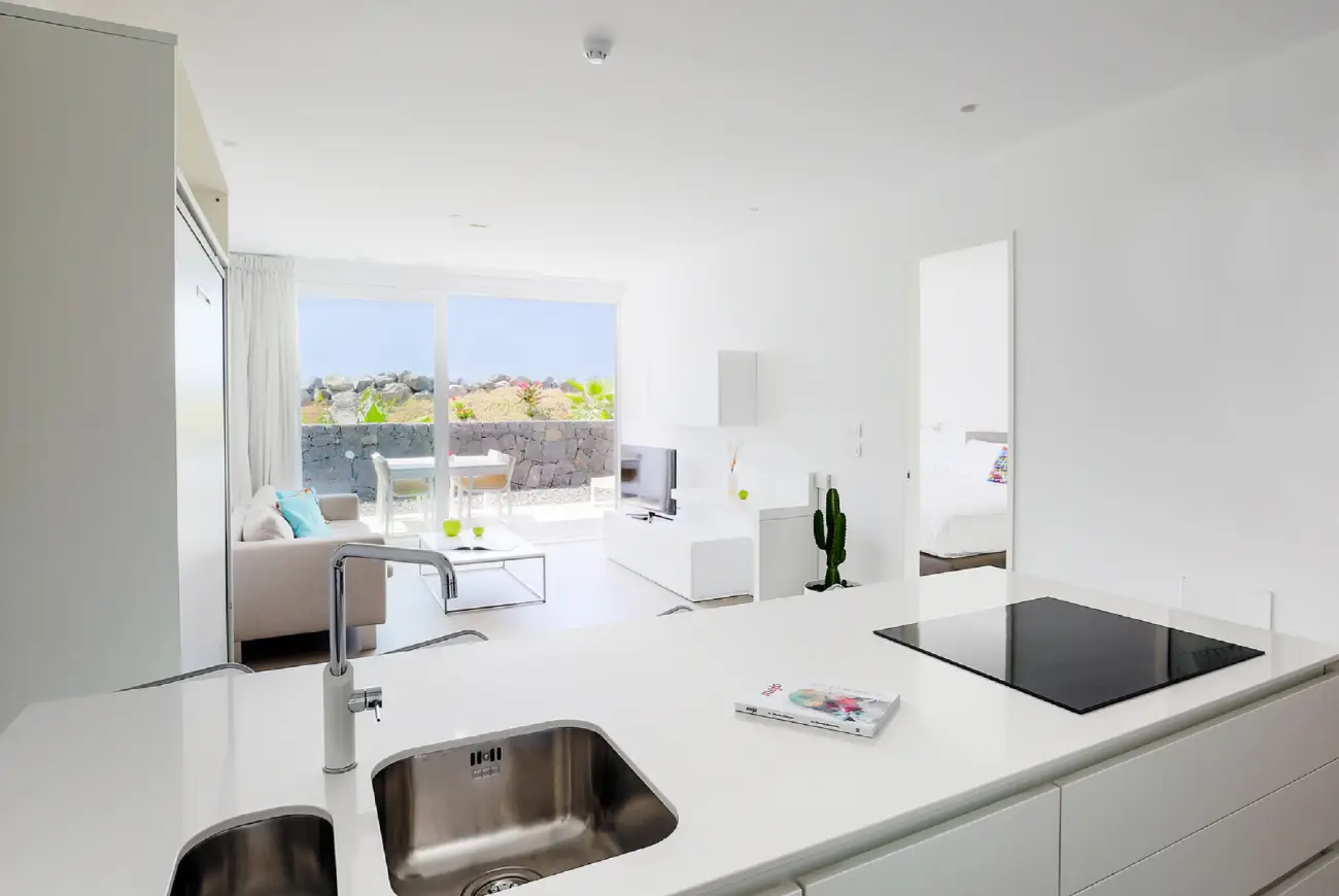 Open-plan kitchen and living room in the Emerald One Bedroom Suite at Baobab Suites