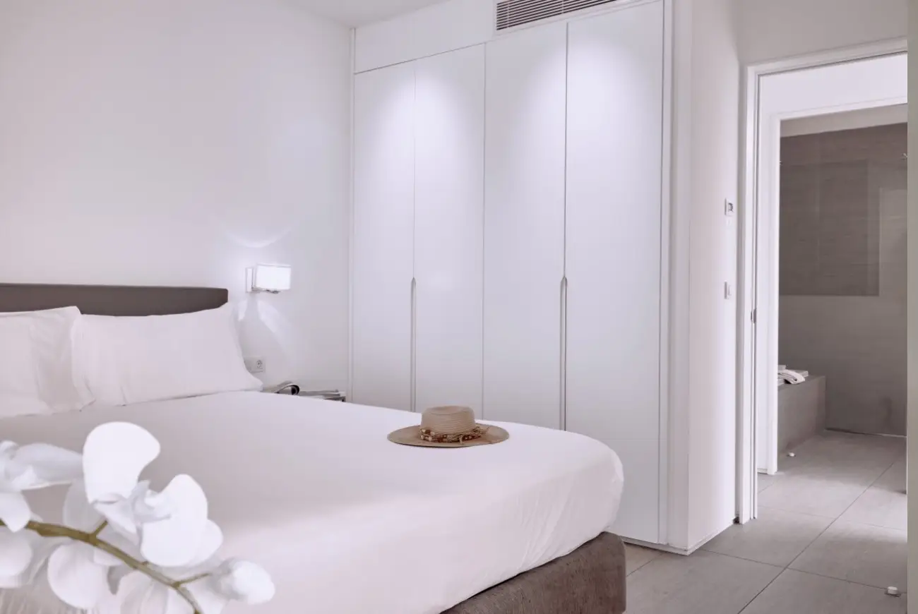 Master bedroom in Emerald Two Bedroom Suite featuring a king bed and contemporary design.
