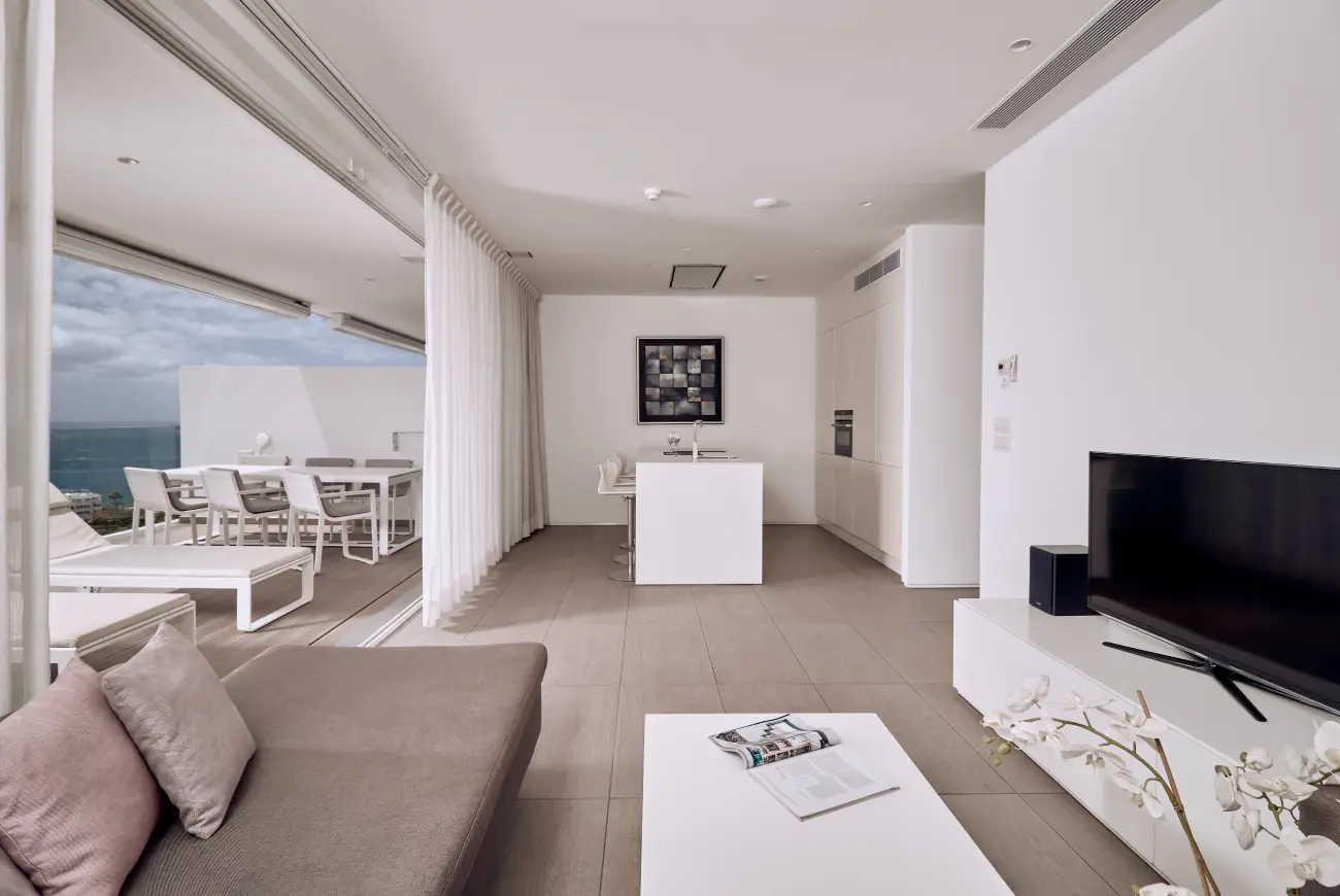 Jade One Bedroom Suite with Side Sea View living room with sofa, TV and terrace access