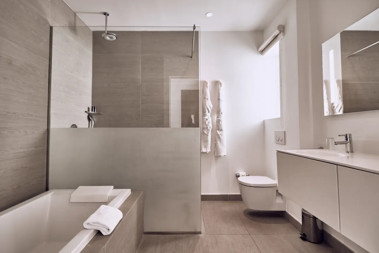 Contemporary bathroom with walk-in shower, bathtub, vanity, and natural-toned finishes.