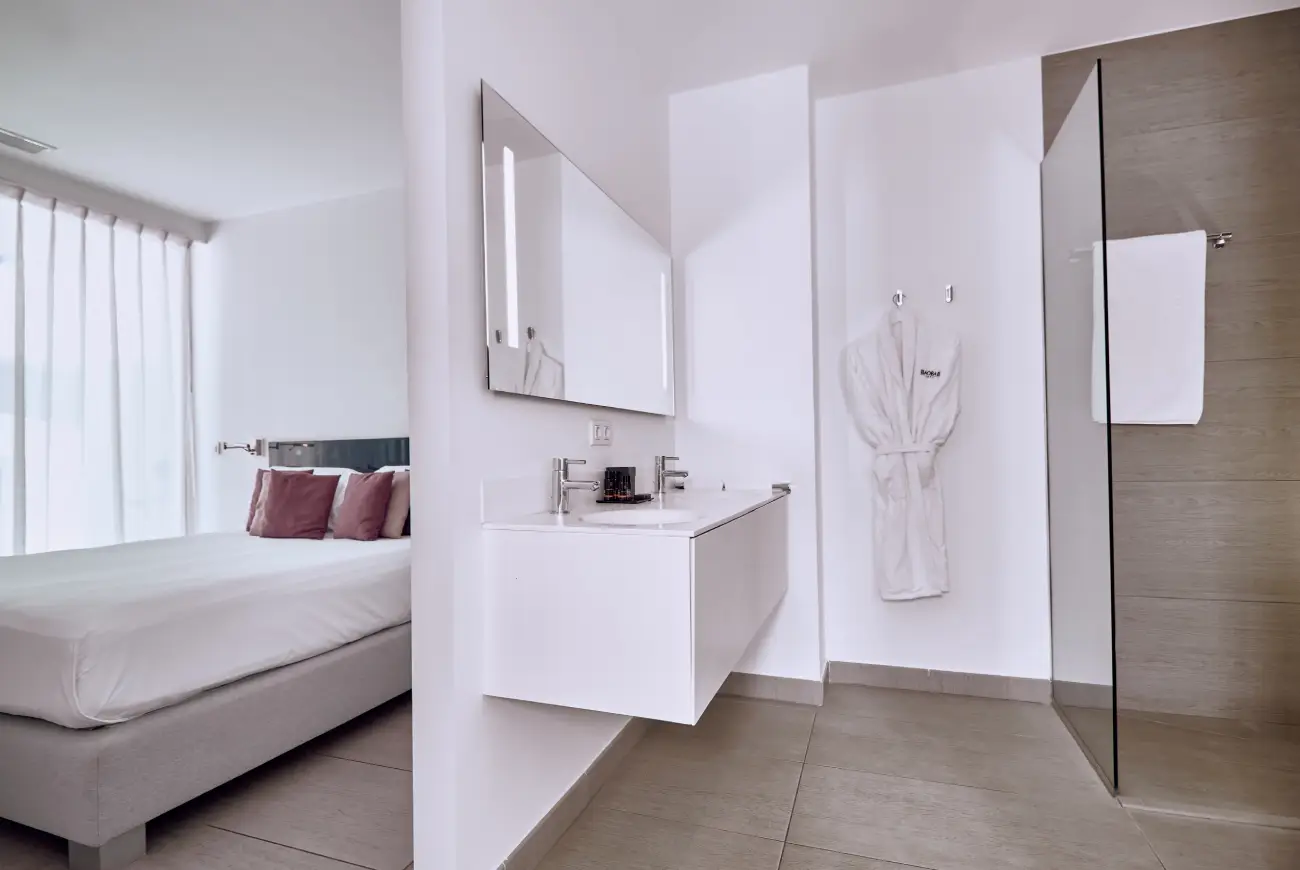 Modern bathroom in Emerald Two Bedroom Suite with vanity area and walk-in shower.