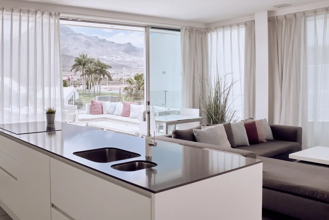 Living area of Emerald Two Bedroom Suite with seating area and terrace access.