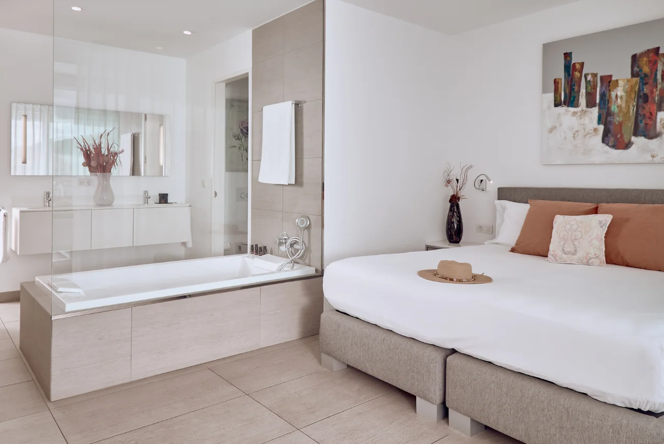 Sapphire Two Bedroom Suite with Sea View and Jacuzzi bedroom with king bed and bathroom entrance
