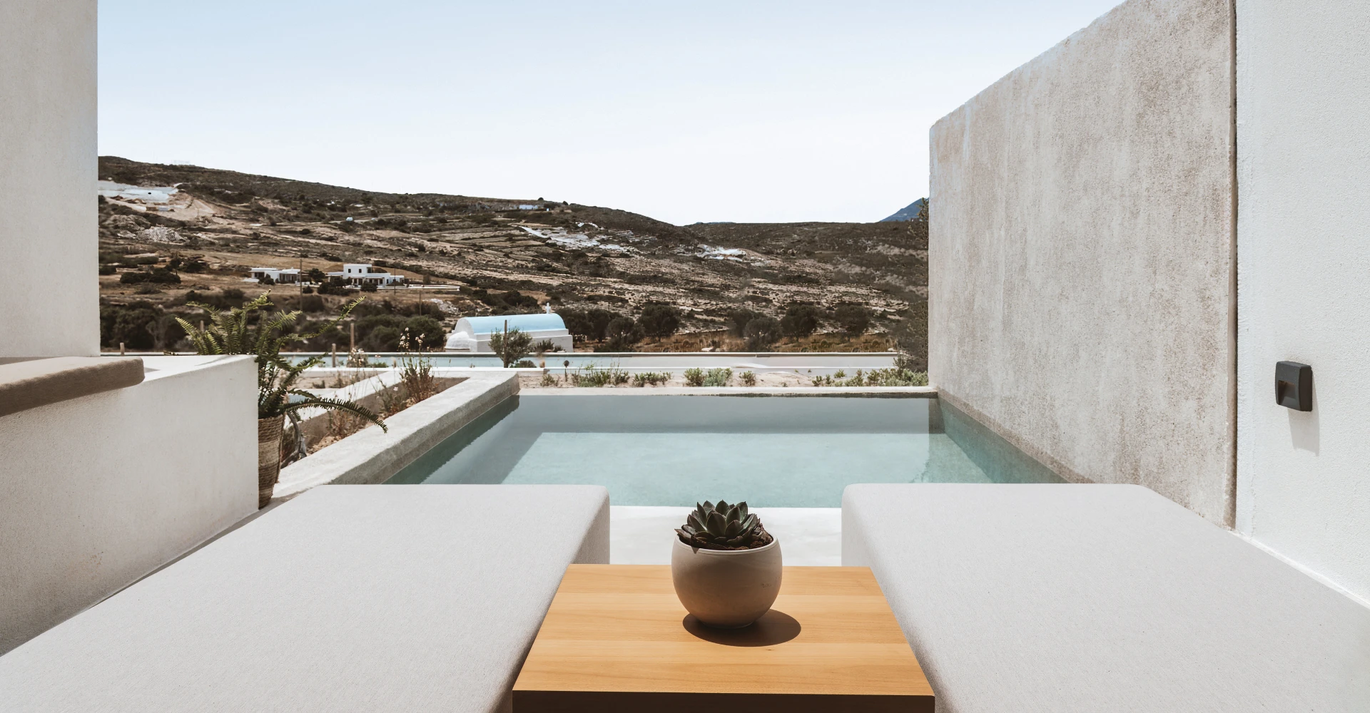 Deluxe Suite with balcony relaxing plunge pool and views of the horizon at Domes White Coast Milos