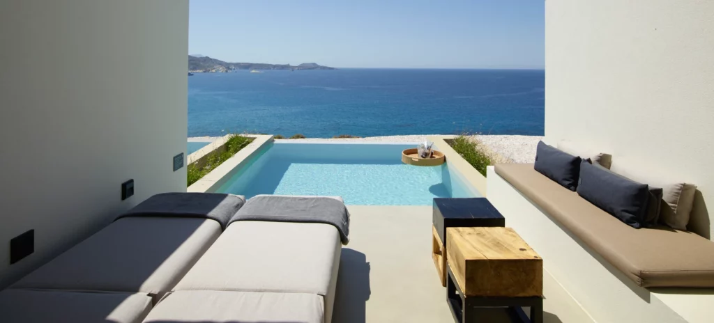Endless sea view balcony in deluxe suite with sunloungers and private pool at Domes White Coast Milos