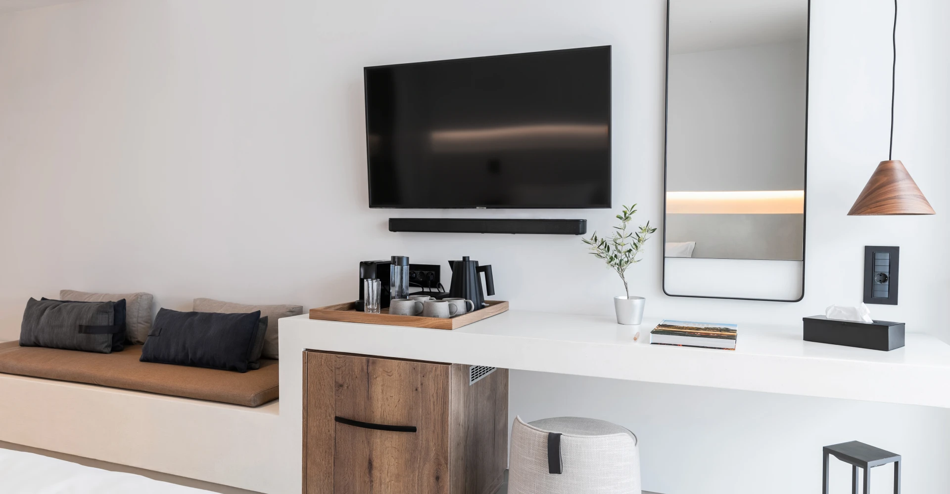 Suite with minimal design and comfy lounge and working area in Domes White Coast Milos