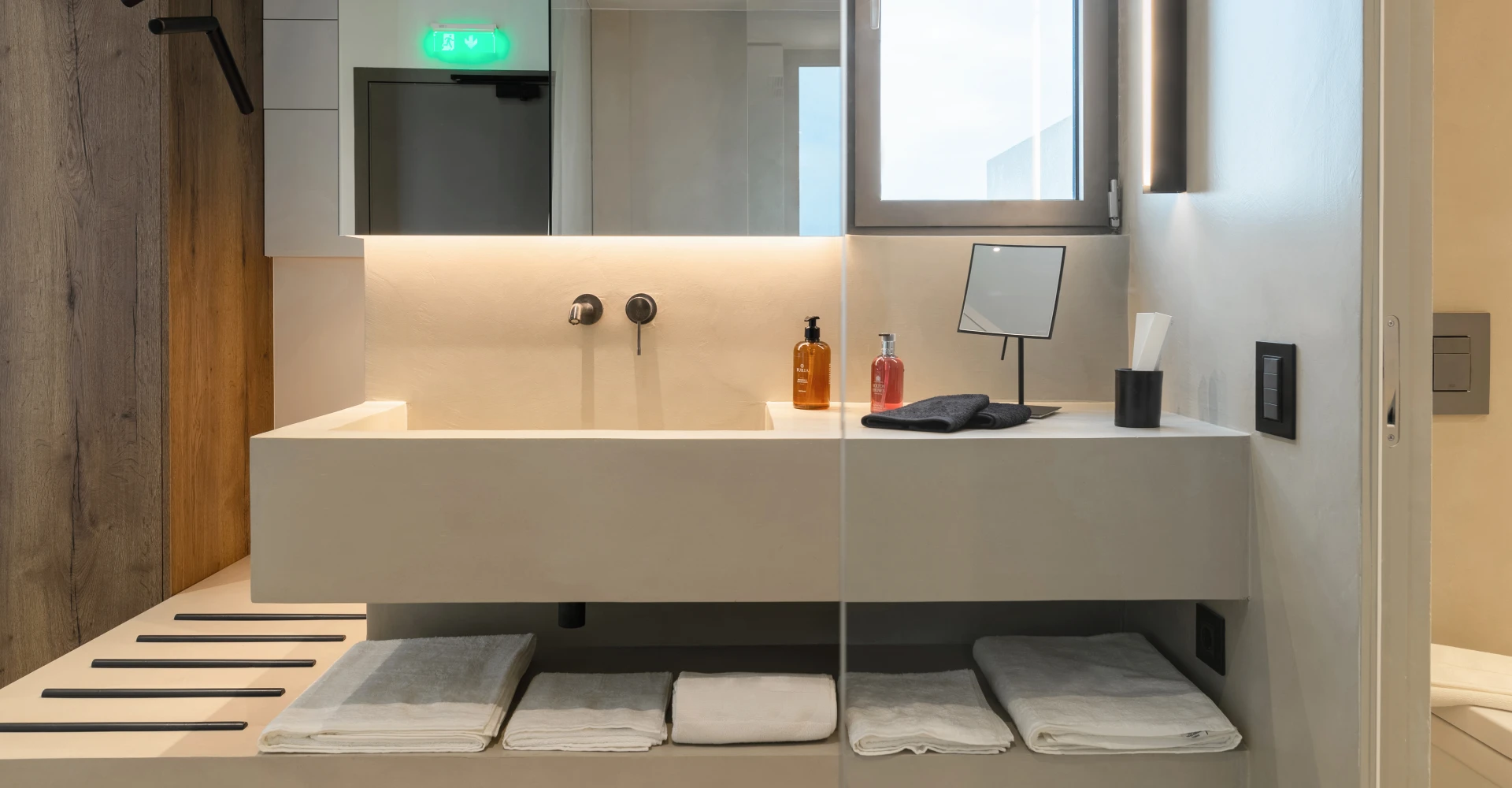 Superior luxury suite bathroom with concrete vanity at Domes White Coast Milos