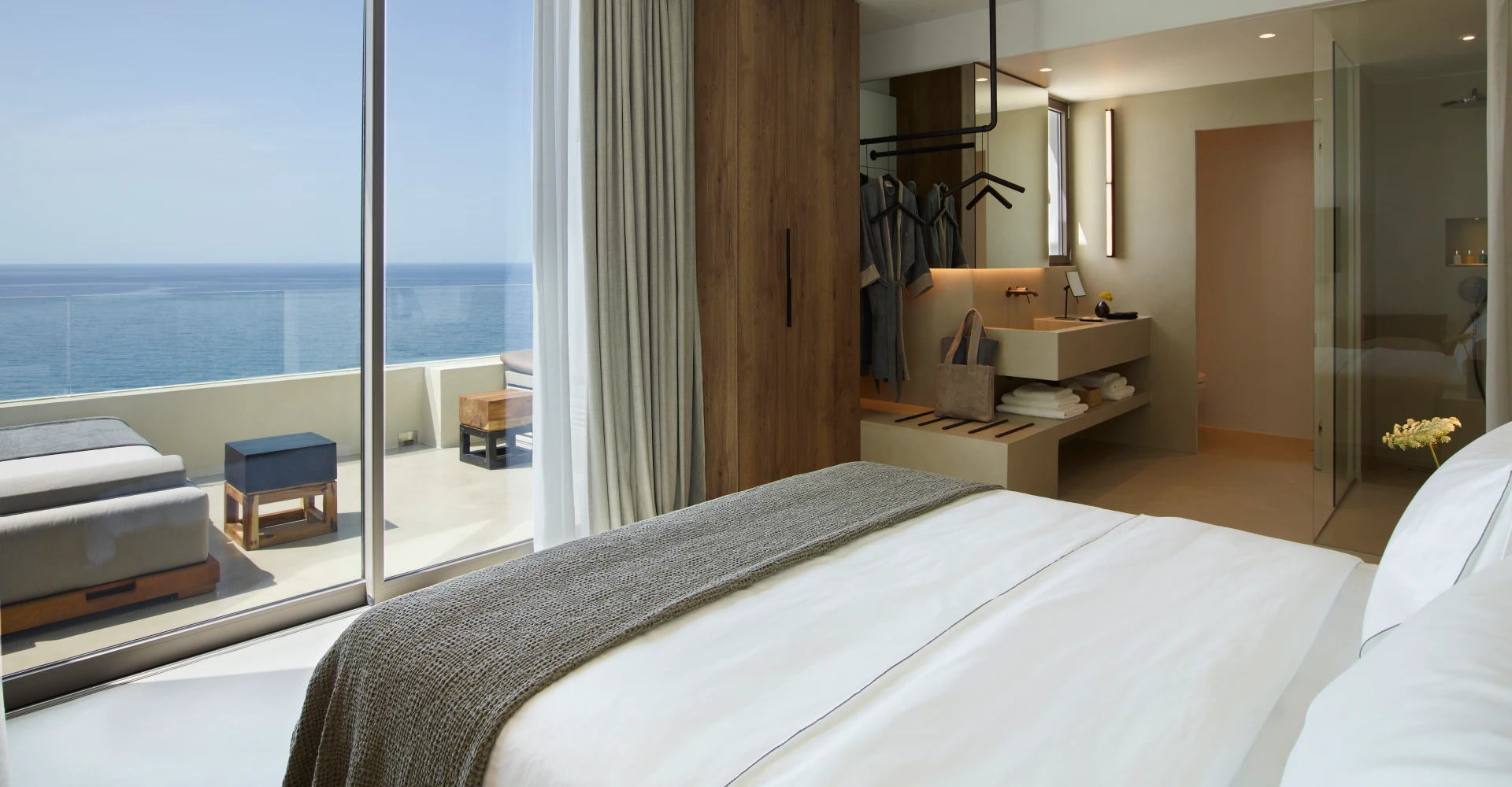 Superior suite for couples only with sea view, king size bed, open space bathroom and veranda at Domes White Coast Milos