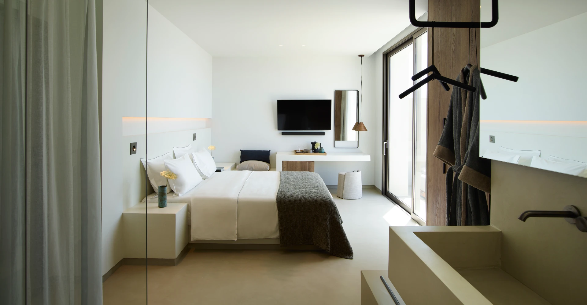 Elegant suite for couples with privacy, king size bed and open space bathroom at Domes White Coast Milos