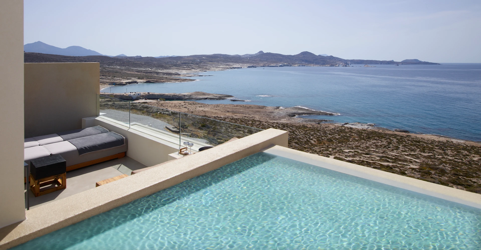 Sea View veranda with sunloungers and plunge pool for relaxation at Domes White Coast Milos