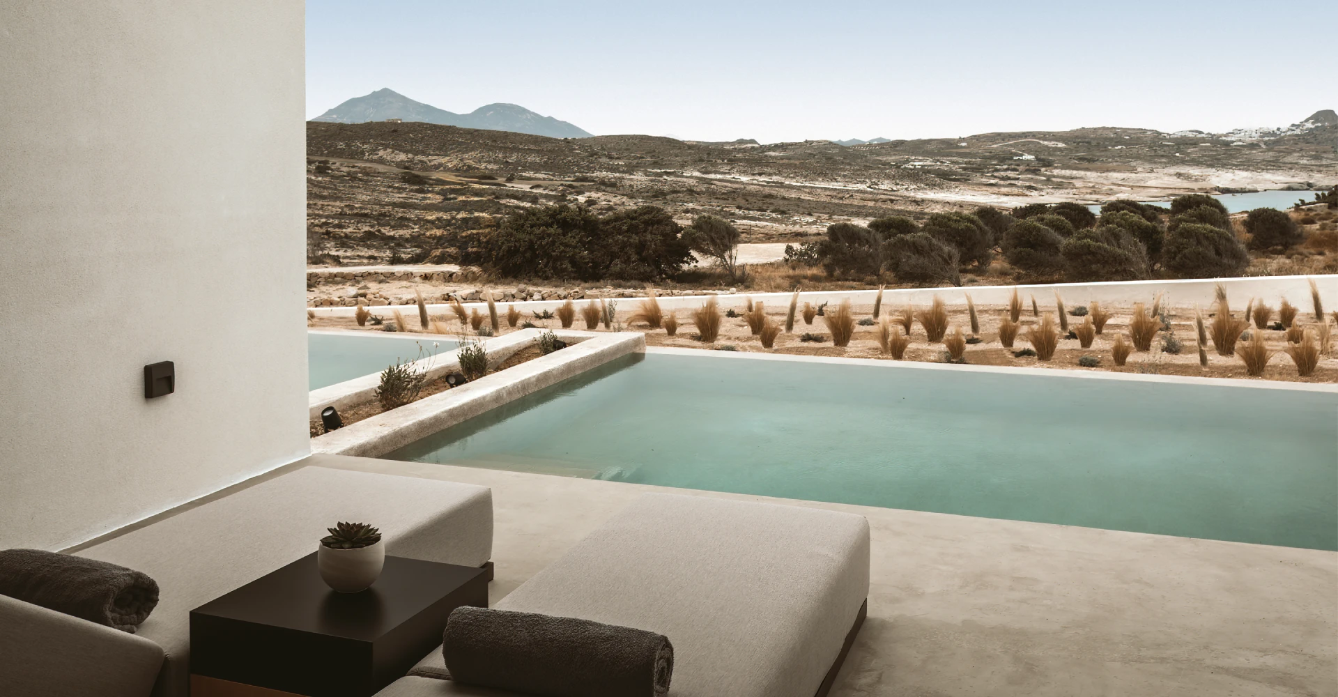 Luxury suite with sunloungers, private pool and horizon view at Domes White Coast Milos