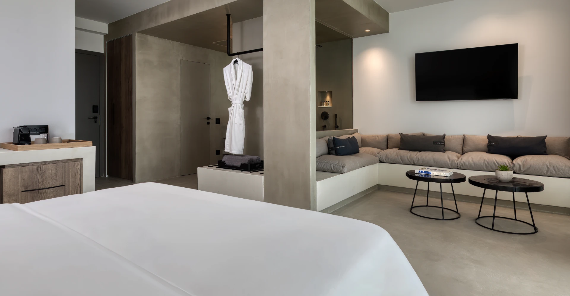 Suite of great luxury with king size bed and spacious open space living area at Domes White Coast Milos