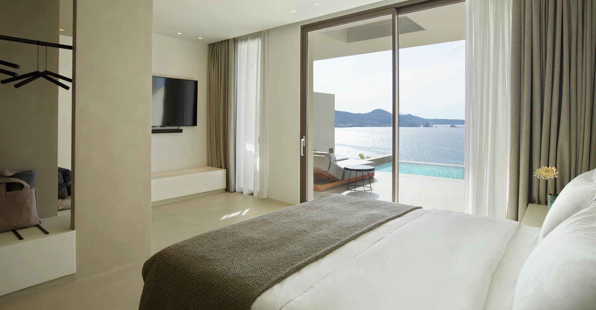 Deluxe luxurious suite with king sized bed of great comfort, private pool and stunning sea views at Domes White Coast Milos