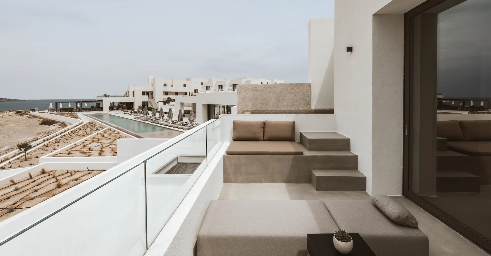 spacious veranda with sun beds and a private infinity pool